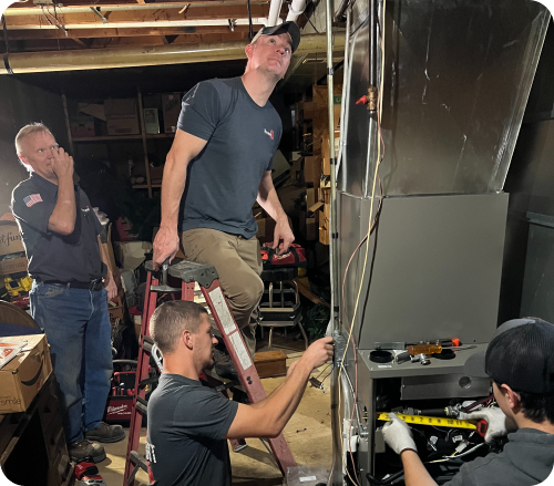 Technicians repairing furnace